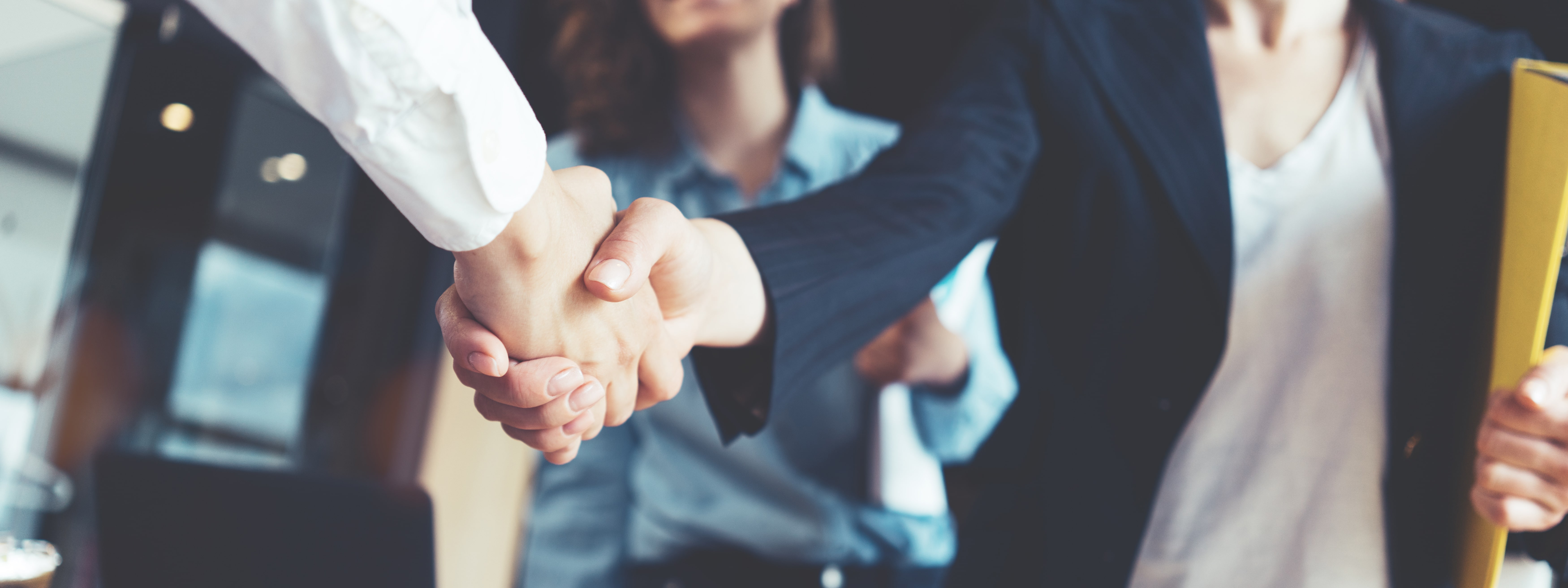 A group of people holding hands and shaking hands.
