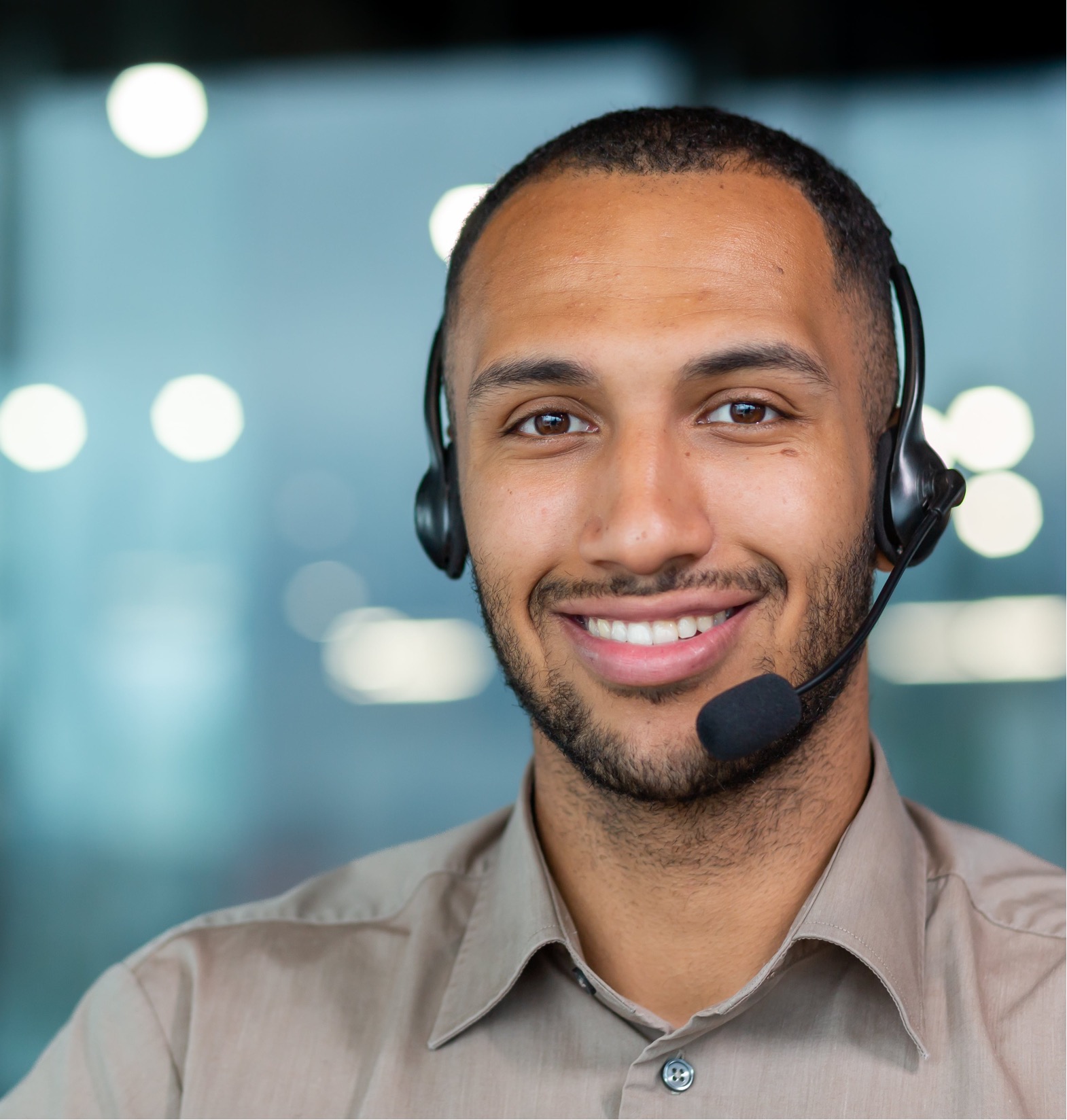 A man wearing a headset smiling for the camera.