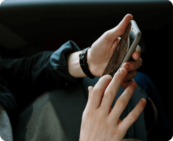 A person using a cell phone while sitting in a car.