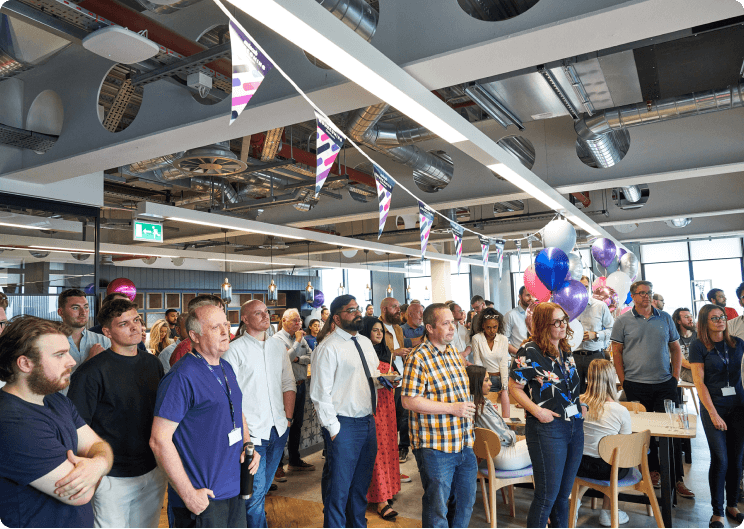 A group of people standing in a room.