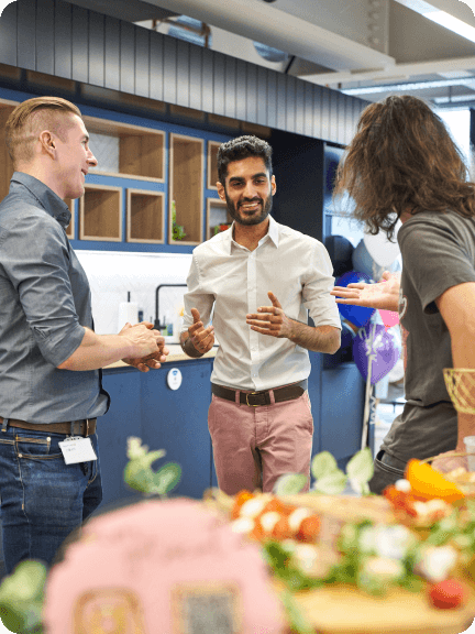 A group of people standing around a table.