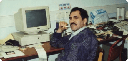 A man sitting at a desk in front of a computer.