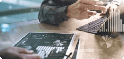 A man sitting at a table using a laptop computer.