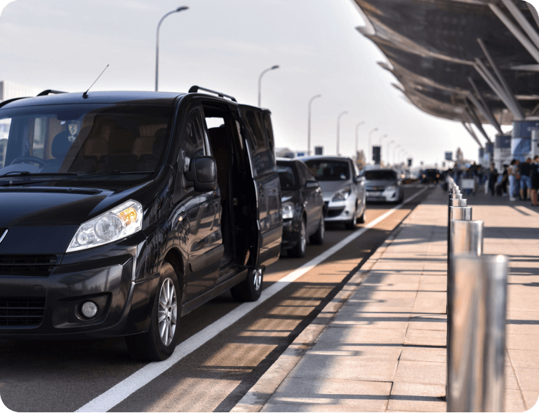 A bunch of cars that are parked on the side of the road.