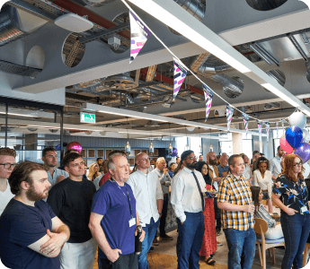 A group of people standing in a room.